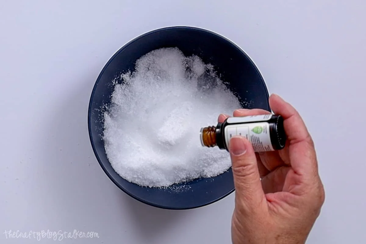 Adding essential oils to salt mixture.