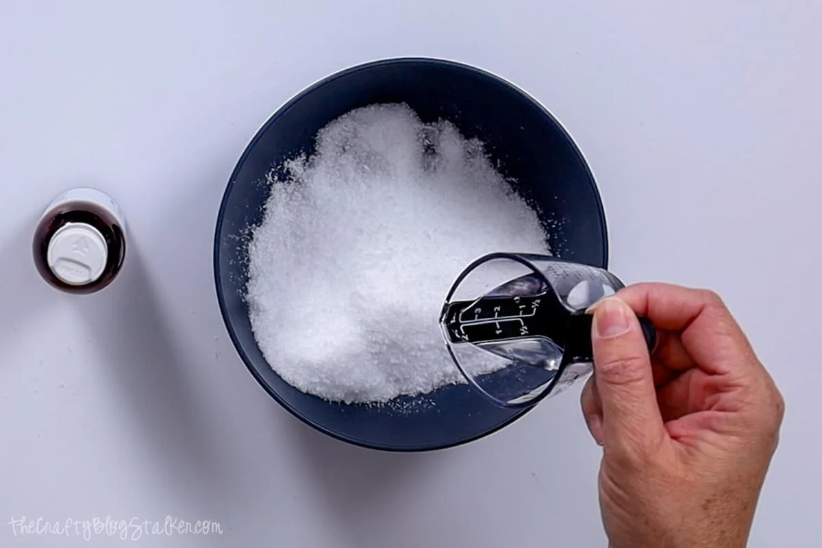 Adding coconut oil to salt mixture.