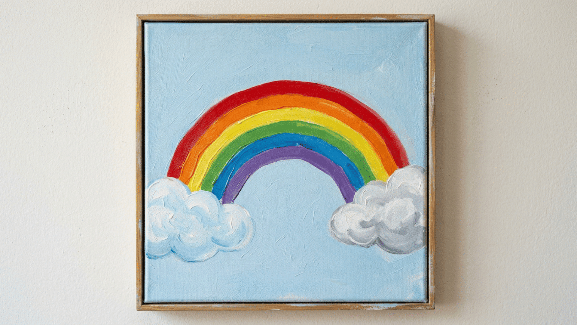 bright curved rainbow arching above two fluffy clouds